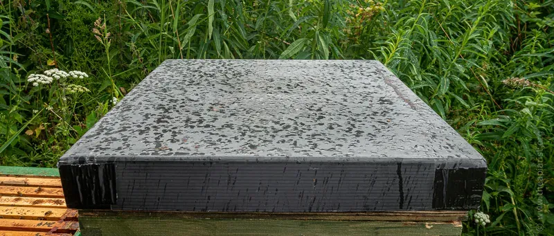 Bee hive roof spotted with rain