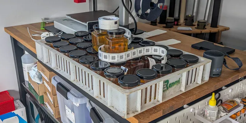 A plastic crate containing forty jars filled with honey ready to be labelled
