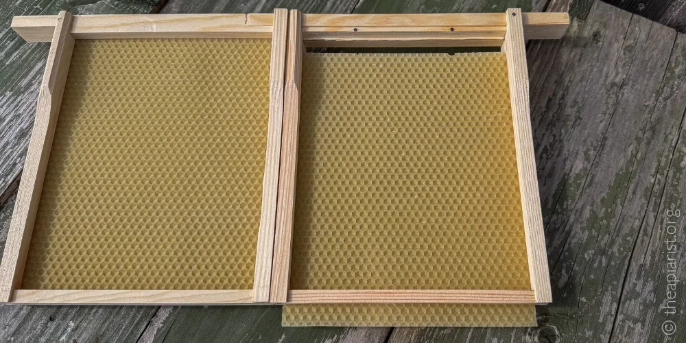 A photo of a sheet of unwired foundation that's broken free from the securing wedge nailed in place