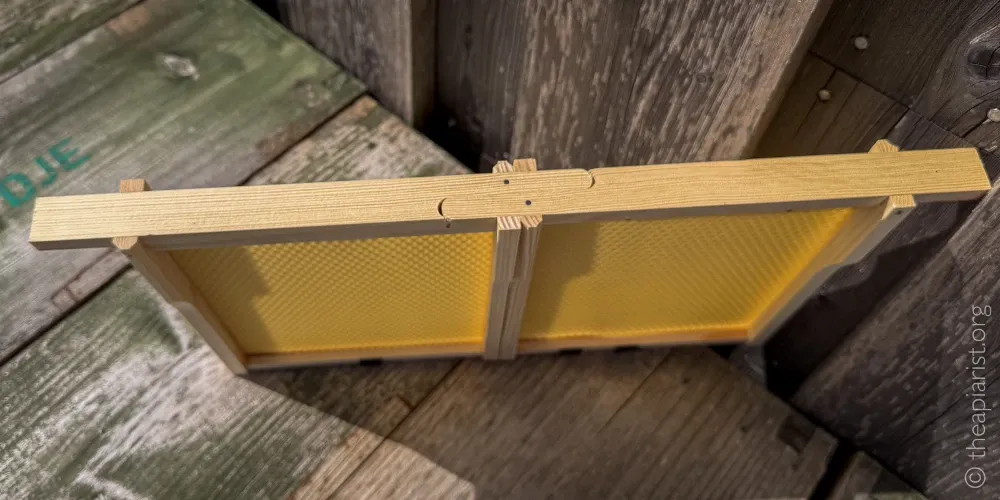 A photo of two Abelo half-width frames for their Mini-Plus hives