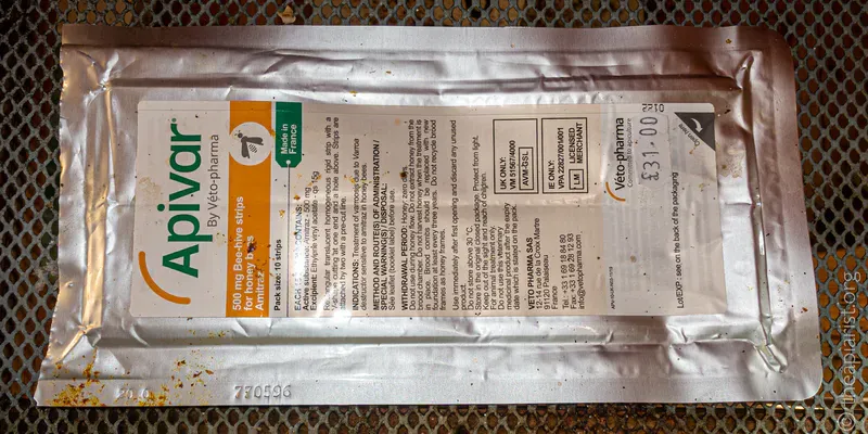 An open foil packet of Apivar, a chemical miticide to treat Varroa mites of honey bees