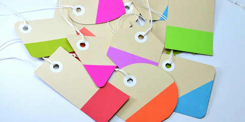 A photograph of coloured cardboard tags on pieces of string