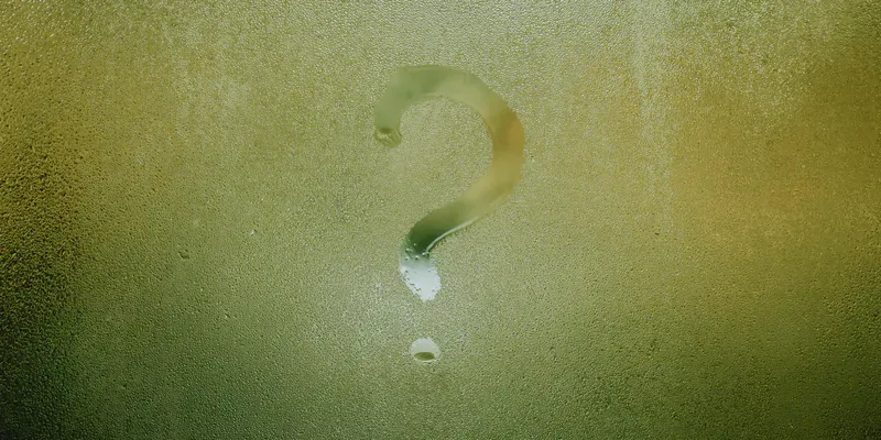 Question mark drawn onto a misted glass window