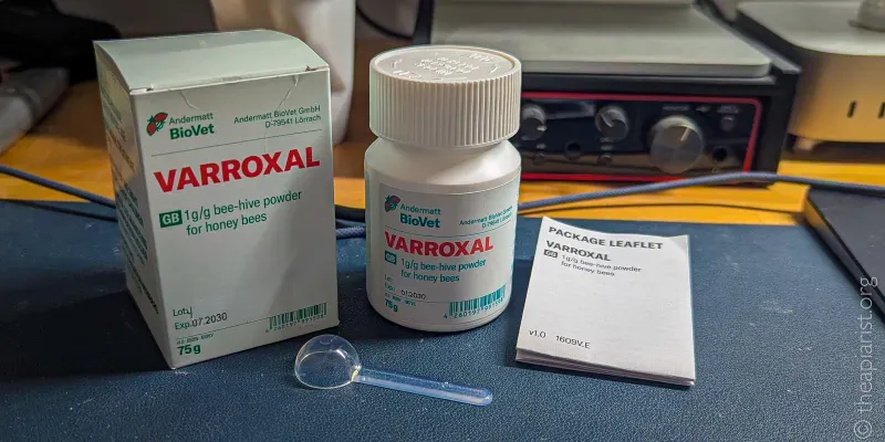 A white plastic veterinary medicine bottle labelled Varroxal, its box and instructions, standing on a blue mat